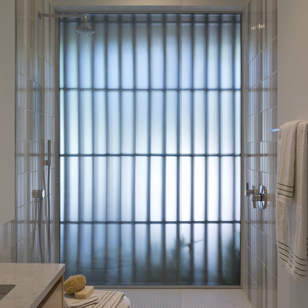 @webberstudio designed bathroom with full glass exterior shower wall and cypress privacy screen. Built by @foursquarebuilders