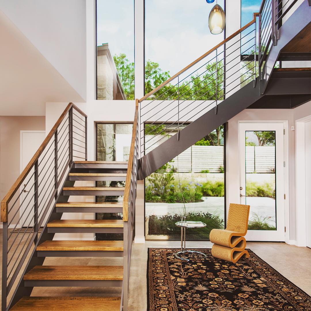 Steel and Hickory wood stairs highlight this two story entry. Built by @foursquarebuilders Designed by photo by @redpantsstudio