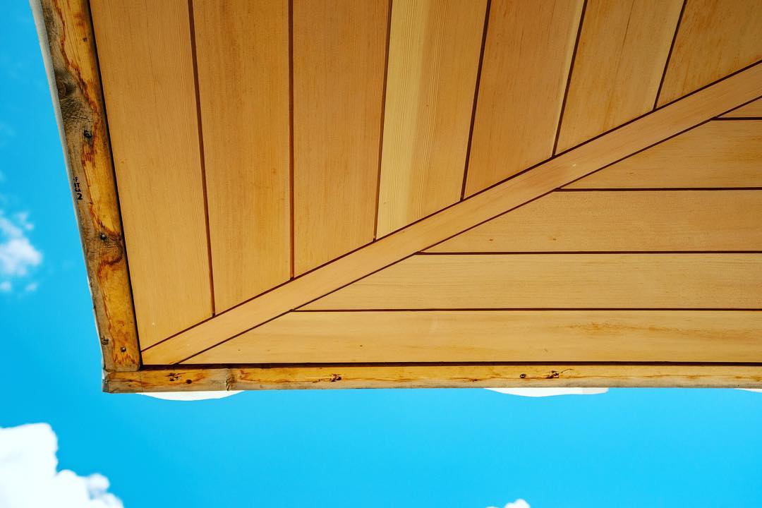 Vertical grain Douglas Fir Soffit complement blue skies. Built by @foursquarebuilders Photo by @redpantsstudio