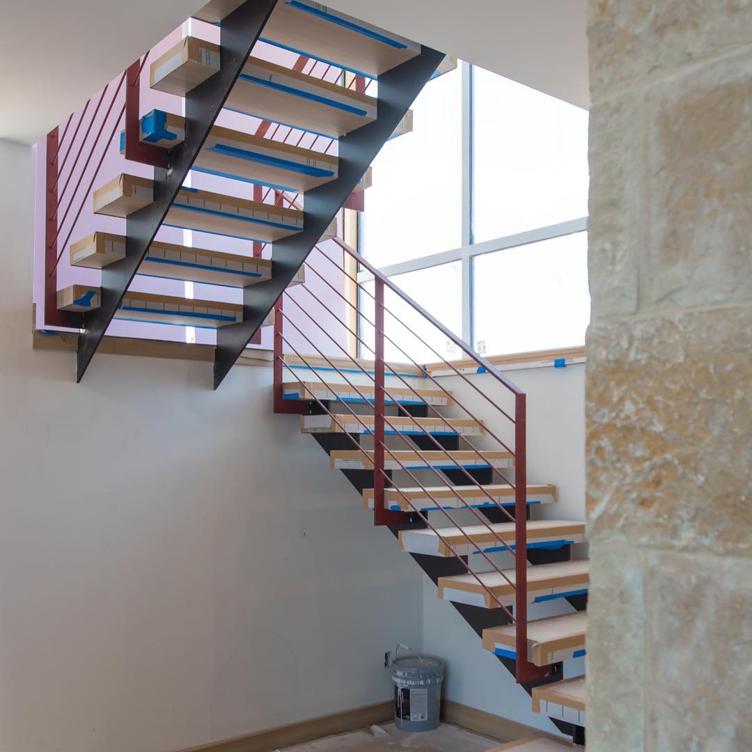 Plate steel stringers with solid oak treads make up this entry stair system designed by @dc_architecture Built by @austin_iron and @foursquarebuilders Treads by @ingrainedbynature Photo by @redpantsstudio
