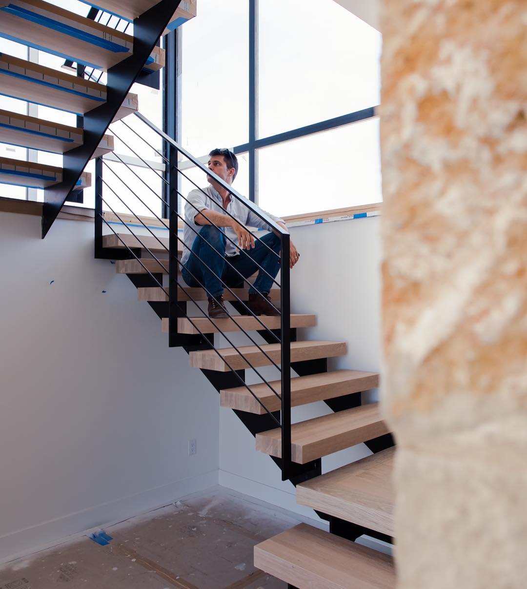 Contemplation of design with Breck Craparo on our latest stair install. Built by @foursquarebuilders & @austin_iron & @ingrainedbynature Designed by @dc_architecture Photo by @redpantsstudio