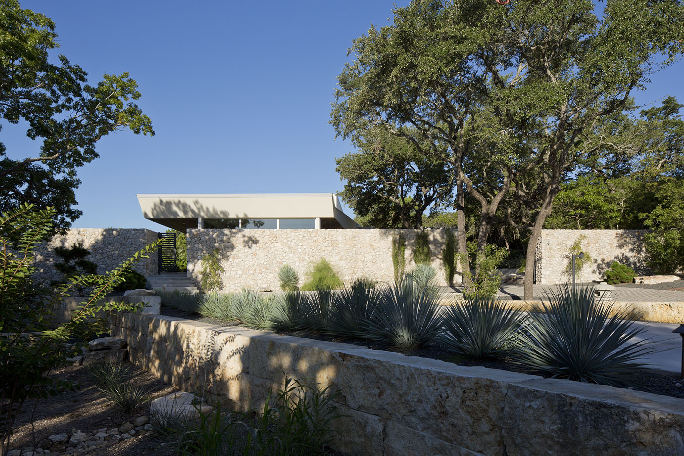 Locally sourced limestone block and stone provide structure and privacy for this estate.