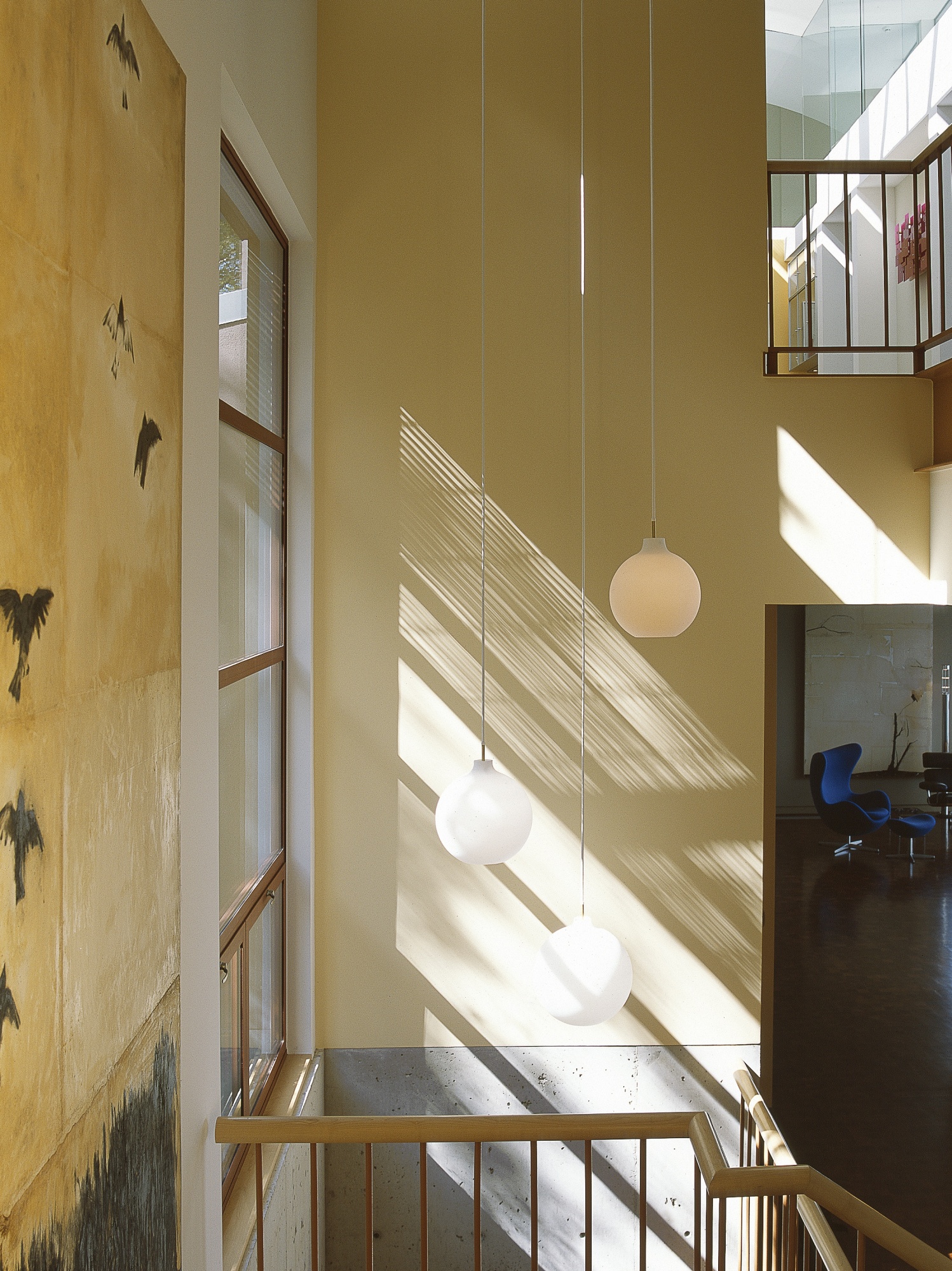 Louis Poulsen lighting provide simple yet elegant solution to a two story volume.