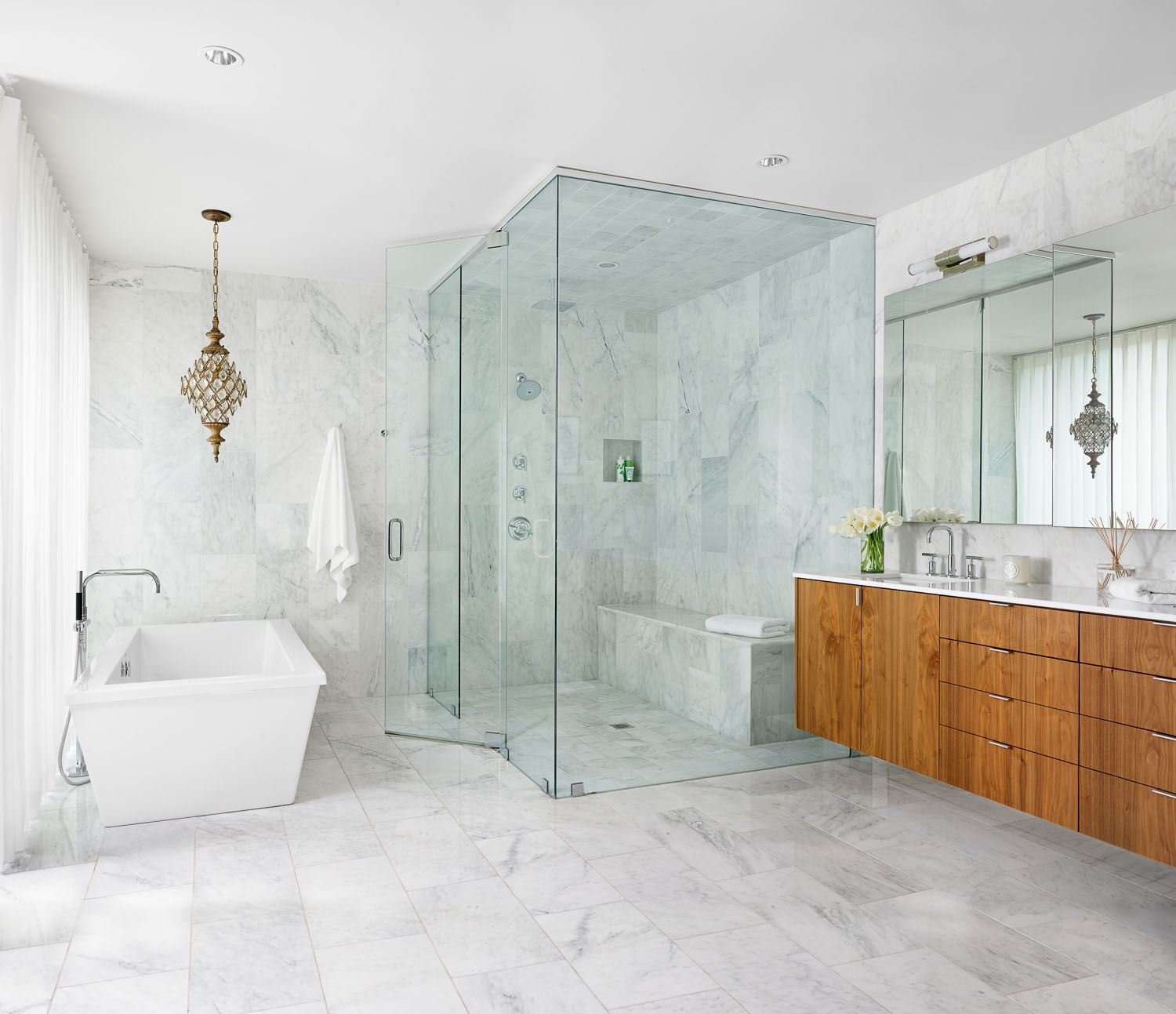 Marble floors and walls provide a spa liking feeling within the master bath.