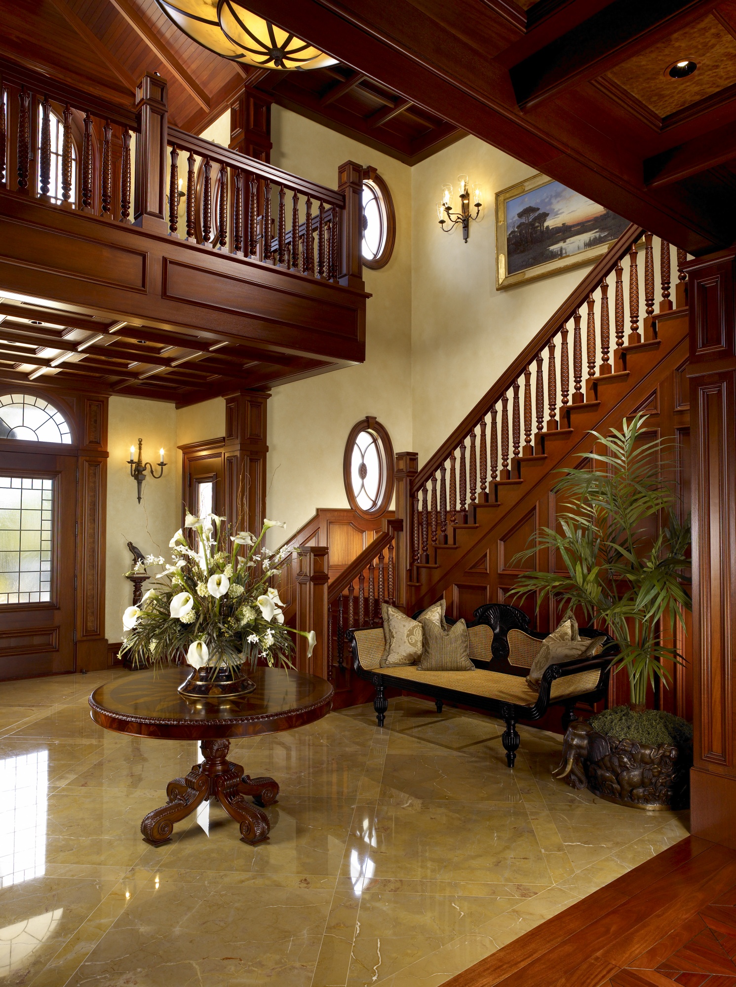Hand carved mahogany banisters provide beauty to this entry stair.
