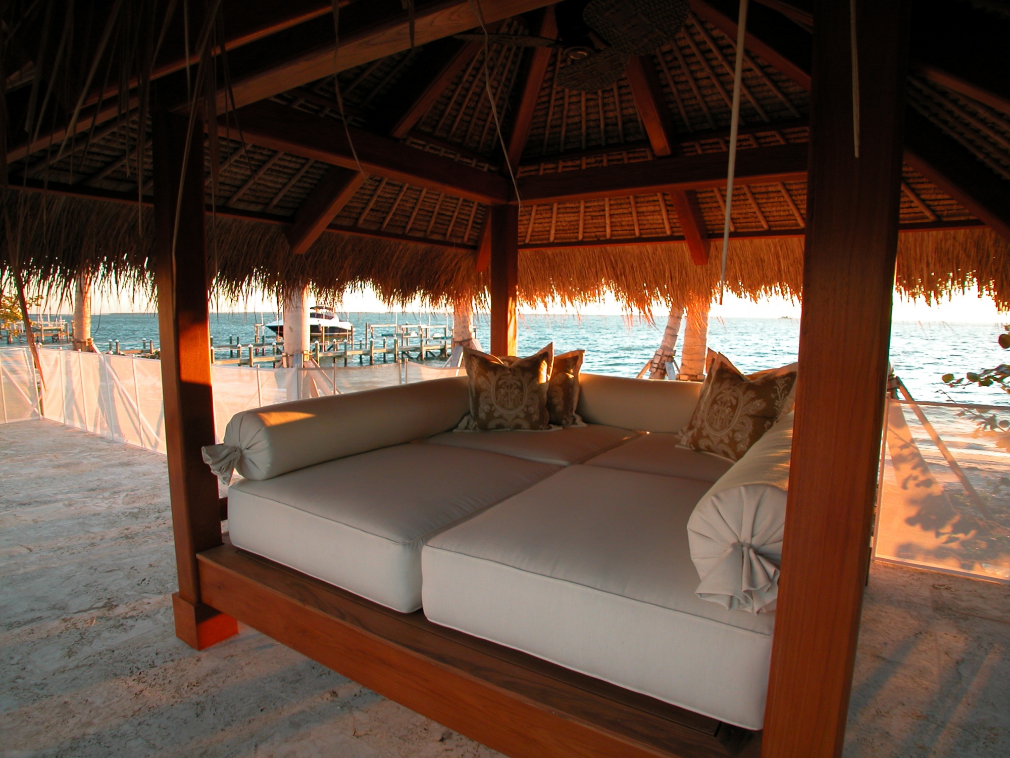 Authentic thatched roof with bamboo and mahogany rafters provide shelter on this oceanside day bed.