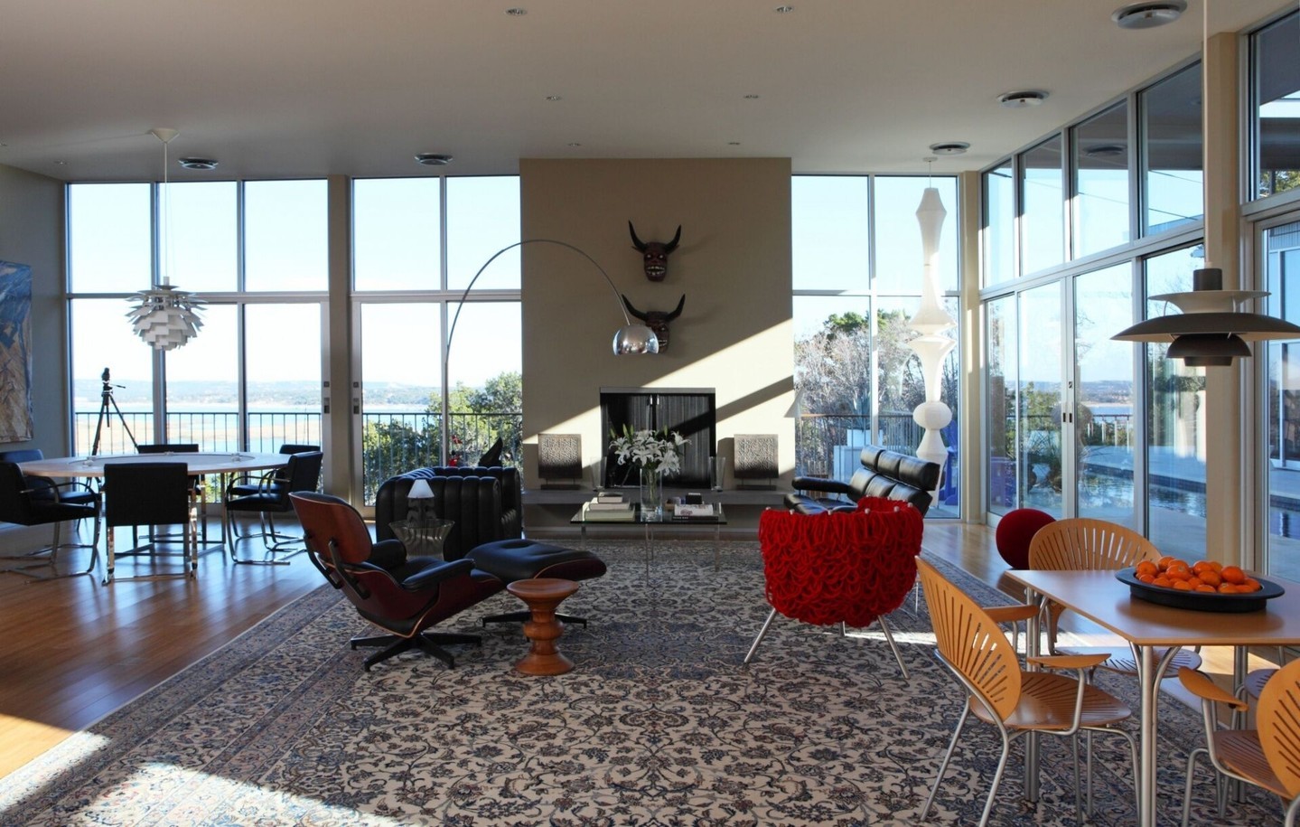 The floating roof effect above three separate structures shows best from this living room. The way morning light moves across this space justifies all that structural work.

Architect: @webberstudio