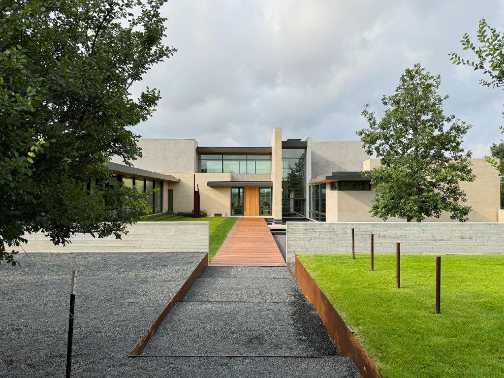 The floating walkway at this Elm Creek home creates a striking sense of arrival. Achieving this effect requires precise leveling, durable materials like steel edging, and careful planning to ensure effortless integration with the natural landscape.

Architect: @grahamarchitecture