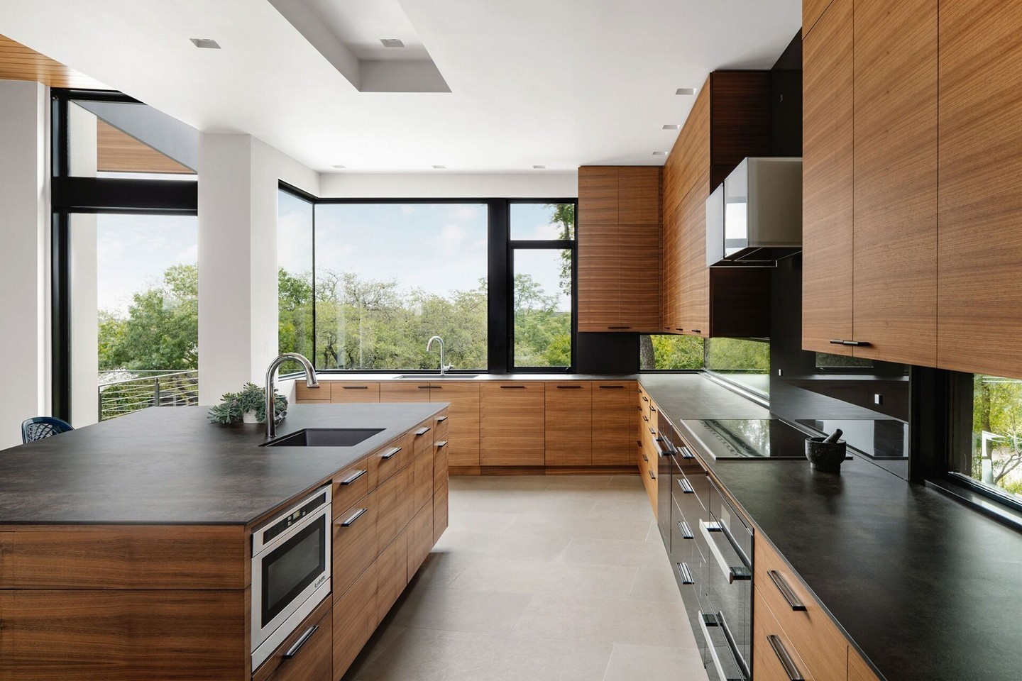 Big windows can be tricky to build - you need strong supports to hold up the house, but too many supports block the view. After years of building, we've figured out clever ways to hide the necessary structure while keeping the windows as large as possible. This kitchen shows off that hard-won knowledge.

Architect: @cornerstonearchitectsinc